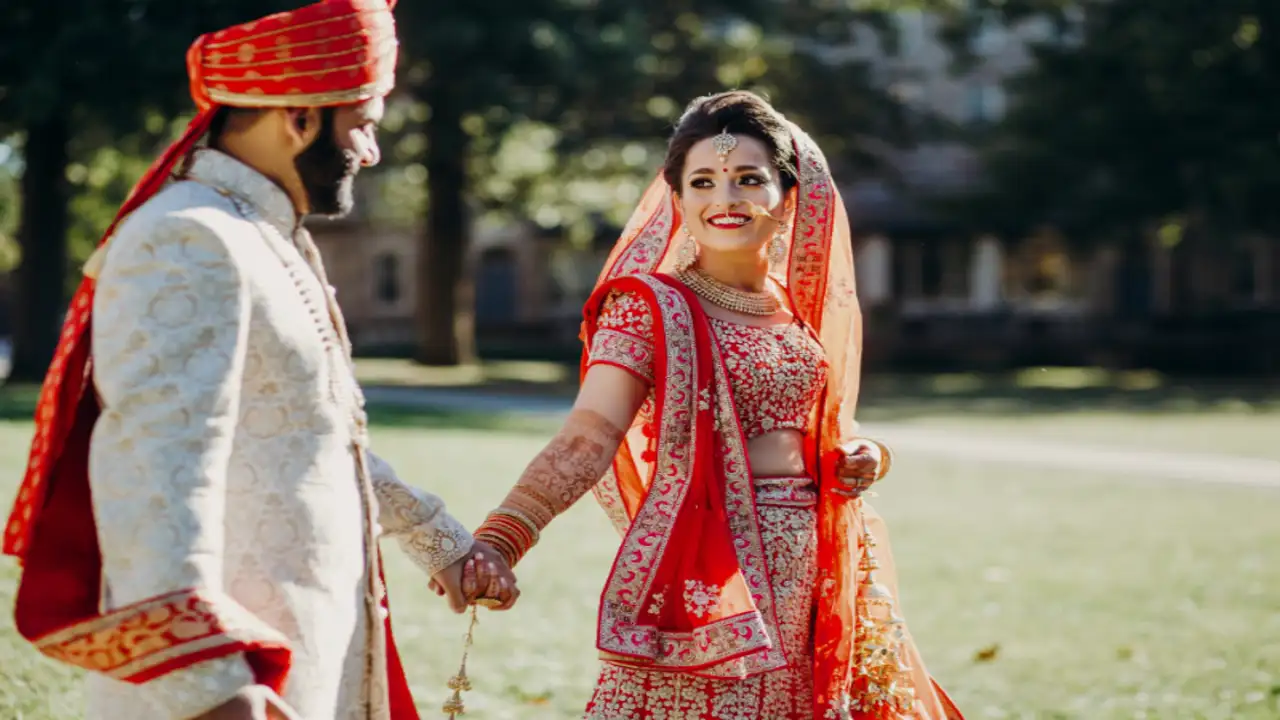 Happy Indian couple celebrating their love marriage success with both families blessing them, showing the positive outcome of using astrology to convince parents