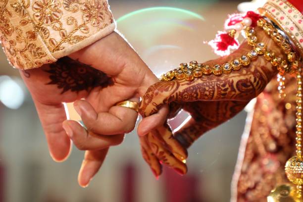 Young Indian person looking worried about marriage timing with astrological symbols in background